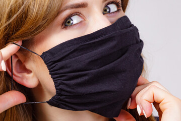 Woman using protective face mask.