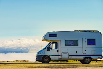 Rv caravan in mountains above clouds