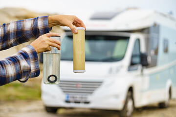 Person showing aqua filter cartridge used in caravan.