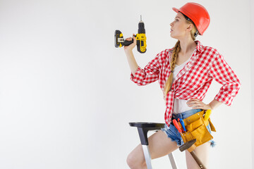 Girl using some power tools for work at home