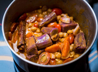 Chef at the kitchen preparing massaman curry with sweet potato and many spices