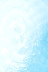 Blue water with ripples on the surface. Defocus blurred transparent blue colored clear calm water surface texture with splashes and bubbles. Water waves with shining pattern texture background.	