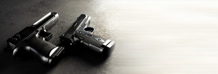 Two guns on black table, criminal concept