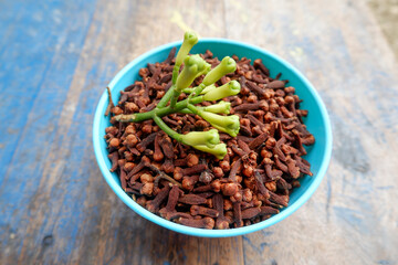 dried and fresh cloves in a bowl. also called cengkih or cengkeh