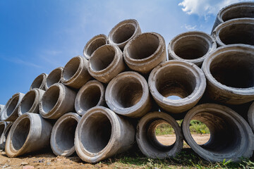 A stack of concrete ring pipes piled and creating a symmetrical arrangement