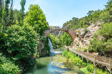 Fototapeta premium Clandras Köprüsü is an ancient bridge in Turkey, the one arch bridge was constructed during the Phrygian era of Anatolia. Arch structures were introduced during the Roman period in Uşak.