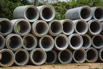 A stack of concrete ring pipes piled and creating a symmetrical arrangement