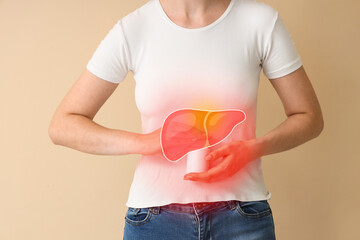 Young woman with bottle of pills suffering from abdominal pain on beige background, closeup