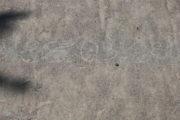 The numbers carved in the gray concrete