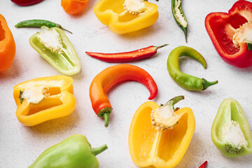 Different fresh peppers on white background