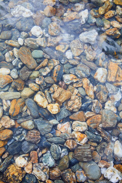 Underwater colorful river rocks.