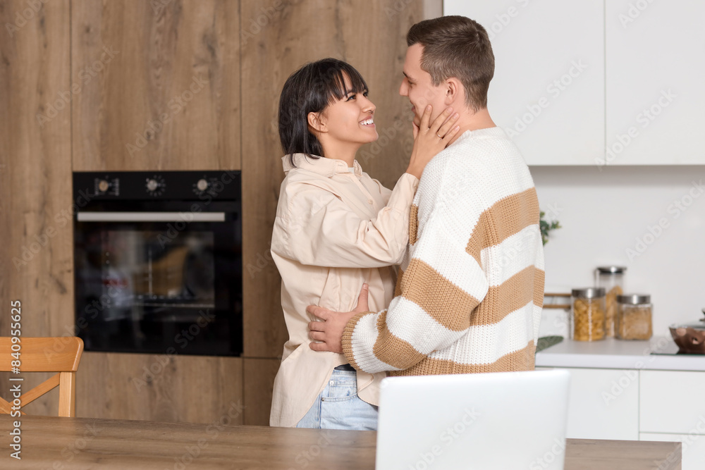 Poster Young loving couple hugging in kitchen