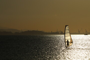 silhouette of a person with a surfboard