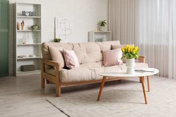 Interior of light living room with sofa and table