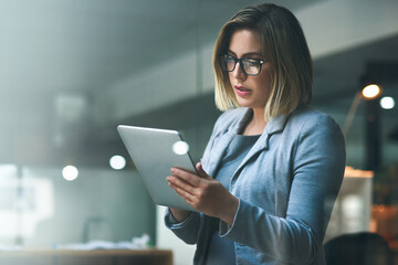 Woman, office and tablet with reading, email or deadline as project manager in digital agency for communication. Female person, business and working on tech for connection as professional for company