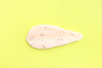 Sample of natural body scrub on yellow background