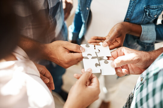 Hands, team and jigsaw for connection, solution and circle with collaboration for creativity at startup. People, group and scrum with puzzle for problem solving, solidarity or link for synergy at job