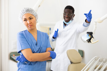 Doctor dentist is dissatisfied with the work of a nurse