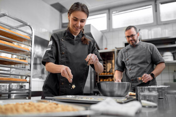 Man and woman preparing French baguettes in kitchen