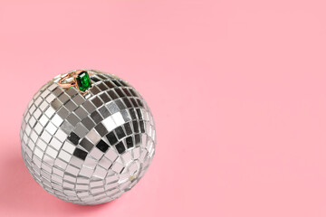 Beautiful ring and disco ball on pink background