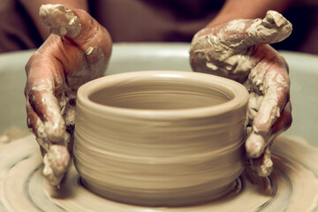Sculptor working with a new product on a pottery wheel