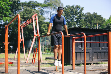 Young Asian Sportsman In Sportswear Exercising, Pull Up Exercises, Preparing For Workout. 