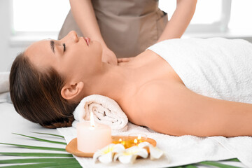 Young woman getting shoulder massage in spa salon, closeup