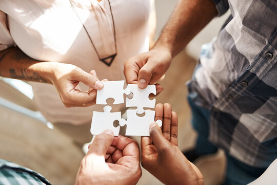 Hands, group and jigsaw for strategy, solution and teamwork in collaboration for creativity at startup. People, integration and scrum for puzzle for problem solving, help and above for synergy at job