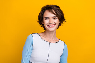 Photo of positive adorable woman wear top smiling showing white teeth isolated yellow color background