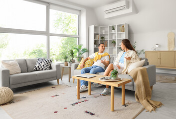 Young couple chatting on sofa at home