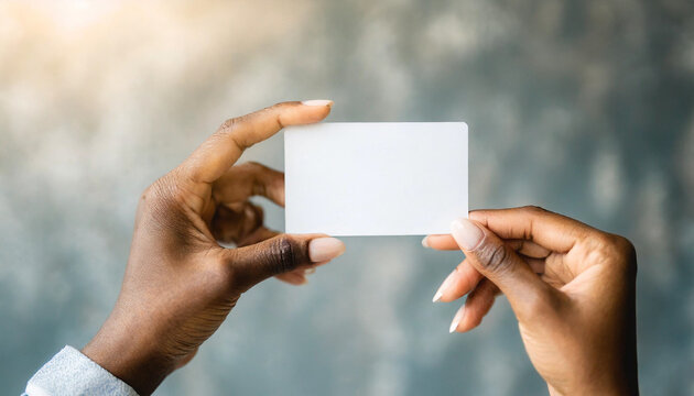 Woman's hand holding white business card, isolated on white background. Concept of professional networking and communication