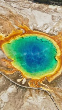 A mesmerizing aerial shot captures the vibrant colors of the Grand Prismatic Spring in Yellowstone Park, attracting tourists and nature lovers with its stunning beauty and natural wonder