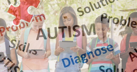 Image of autism text over kids friends using electronic devices
