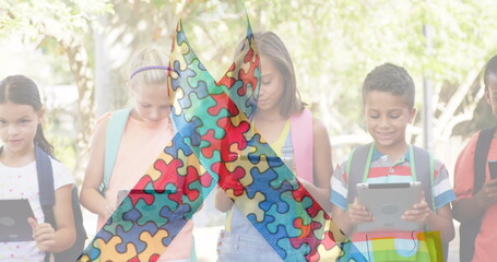 Image of colourful puzzle pieces over kids friends using electronic devices