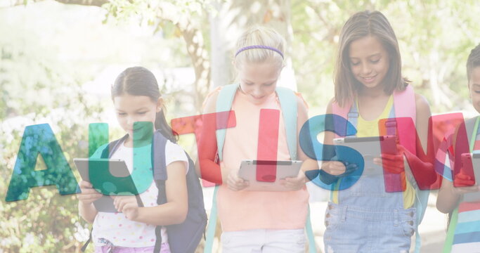 Image of colourful puzzle pieces and autism text over kids friends using electronic devices