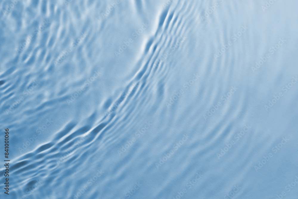 Poster Rippled surface of clear water on light blue background, top view