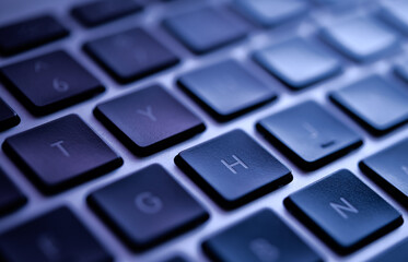 Close-Up of Modern Laptop Keyboard in Blue Tones Highlighting Technology and Design