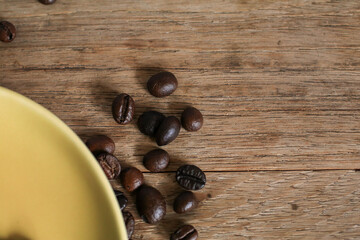 Coffee beans on wooden table. Top view with copy space for your text. Retro style toned