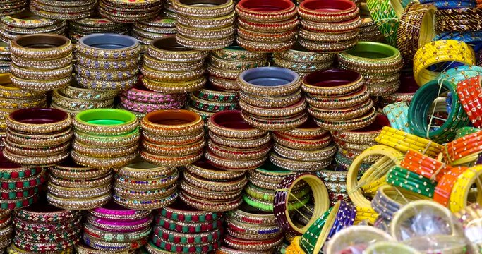 Bangles and bracelets are arranged for sale on the street side in Udaipur, India.