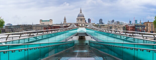 Dome of St. Paul's cathedral seen across Millennium bridge in London. England