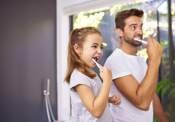 House, brushing teeth and father with girl, cleaning mouth and morning routine with grooming. Family, dad and daughter with fresh breath, dental hygiene and oral care with dental wellness and playful