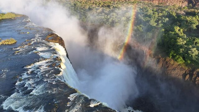 Water Fall Rainbow At Victoria Falls In Matabeleland North Zimbabwe. Giant Waterfalls. Nature Landscape. Victoria Falls At Matabeleland North Zimbabwe. Zambezi River. Travel Scenery.