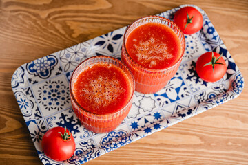 Two glasses of fresh tomato juice on a table