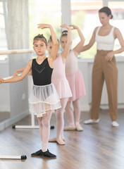 Fourth position - little girls learn ballet at a choreography lesson