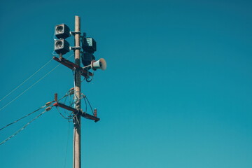 broadcast pole and telephone transceiver with blue sky, public loudspeakers broadcast