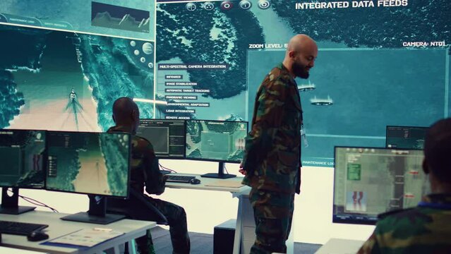 Lieutenant general coordinating his army troops for a complex military operations, ensuring every unit is synchronized and informed about a new national safety mission. Command center. Camera B.