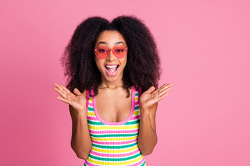 Photo of overjoyed woman with perming coiffure dressed knitwear tank in heart sunglass staring on...