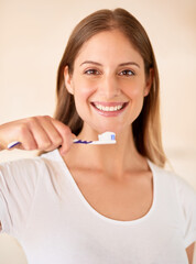 Portrait, woman and smile with toothbrush in home for hygiene and clean teeth. Female person, face and happy with toothpaste for fresh breath or smell with oral or dental health in bathroom