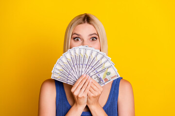 Portrait photo of wealthy shopaholic young blond lady in singlet holding her money hiding face...