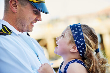 Happiness, uniform and father carry girl with love, patriotic service and family support for military captain. Dad, child and hug with marine soldier for excited reunion and hero with navy seal job